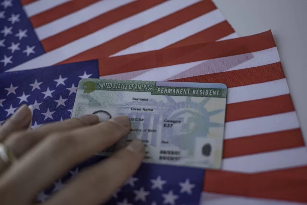Green Card on top of American flag