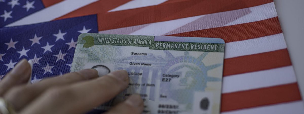 Green Card on top of American flag