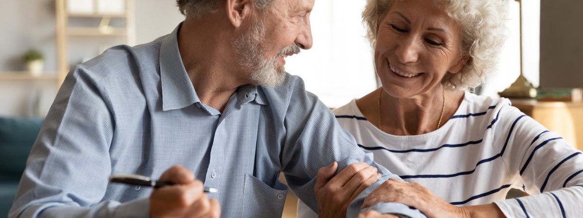 Older couple discuss agreement ready to sign contract