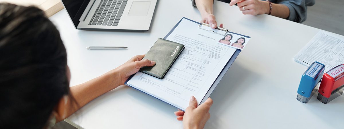 A citizenship lawyer and a client going over paperwork at a desk in El Paso.
