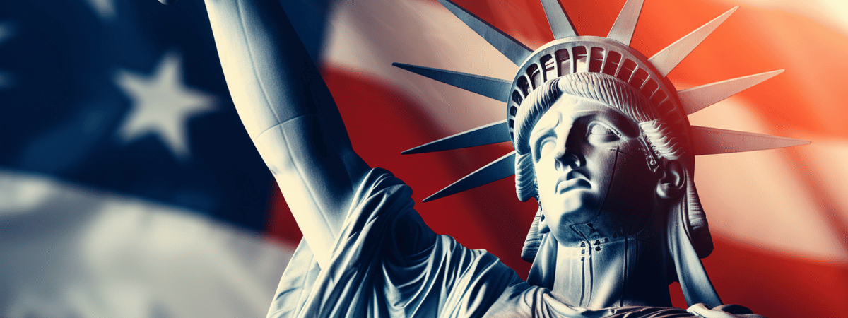 The statue of Liberty in front of the American flag