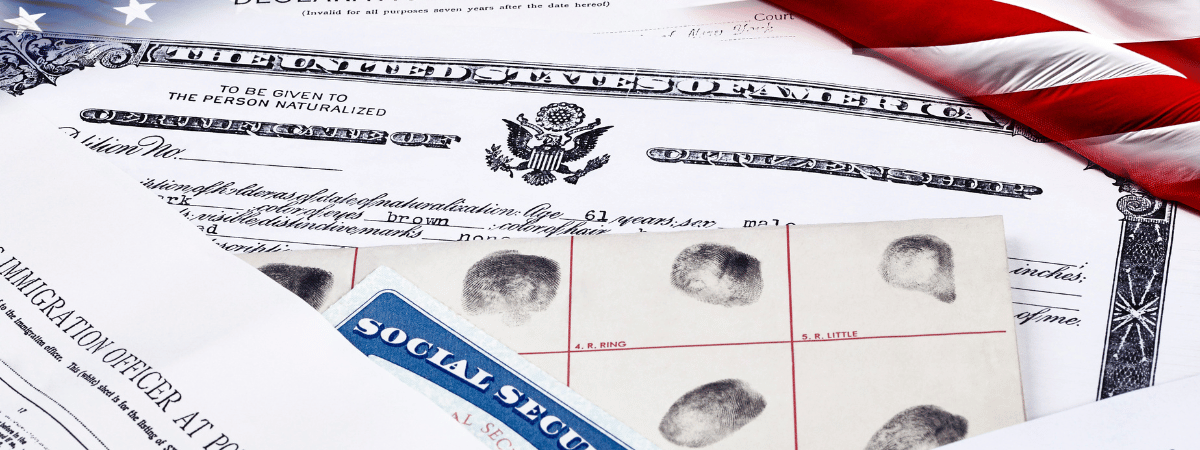 Immigration papers with an American flag in the background.