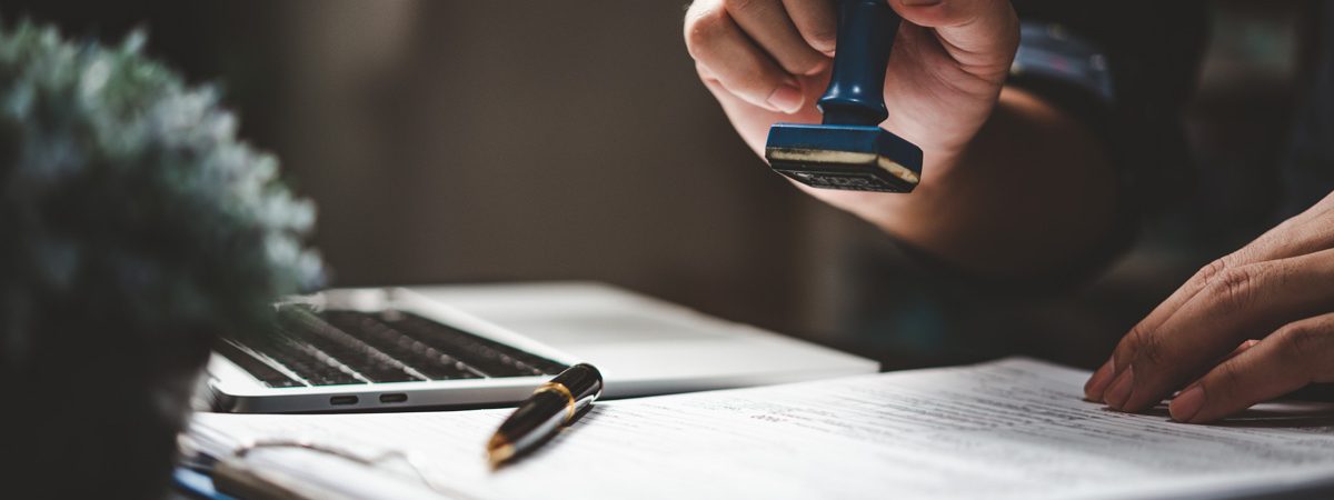 A person stamping immigration visa documents in El Paso.