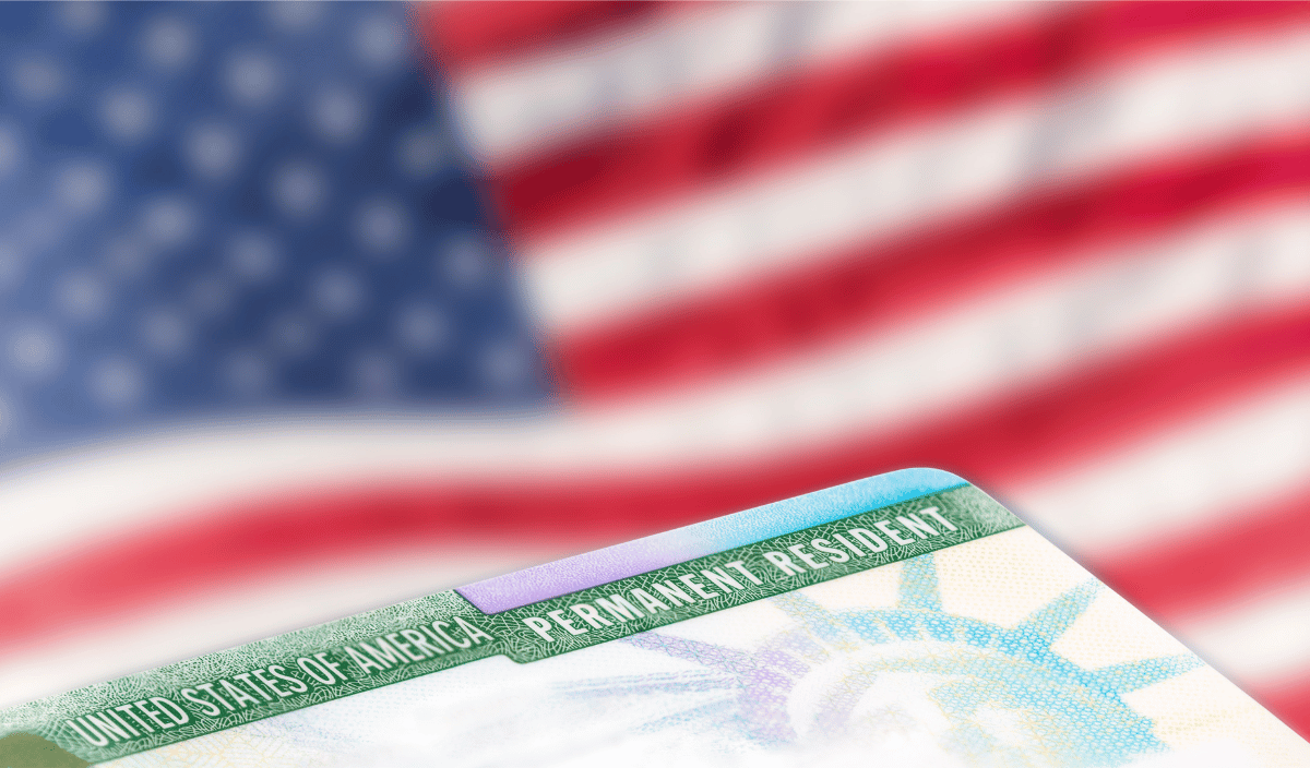 A naturalization card with an American flag in the background